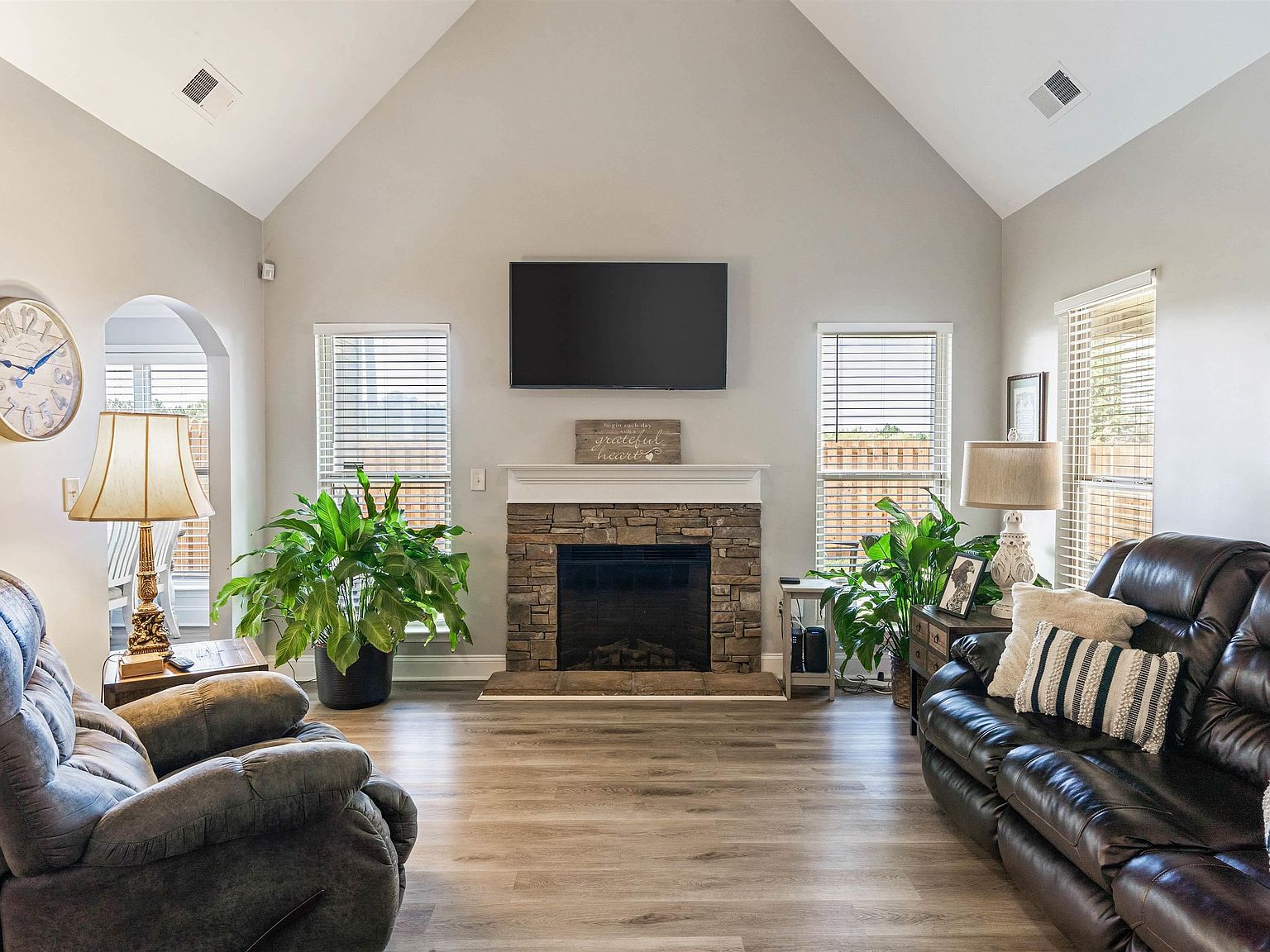 Vaulted living room with stone fireplace
